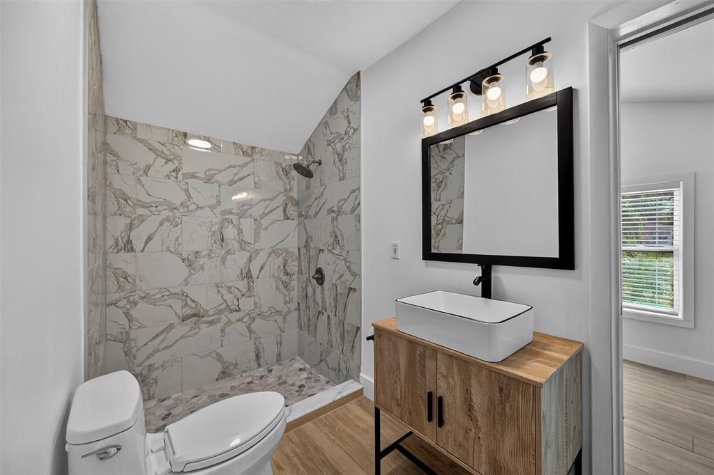 181 Northeast 15th Terrace Boca Raton, FL 33431 - Photo 40 of 51 a bathroom with a sink toilet a mirror and shower