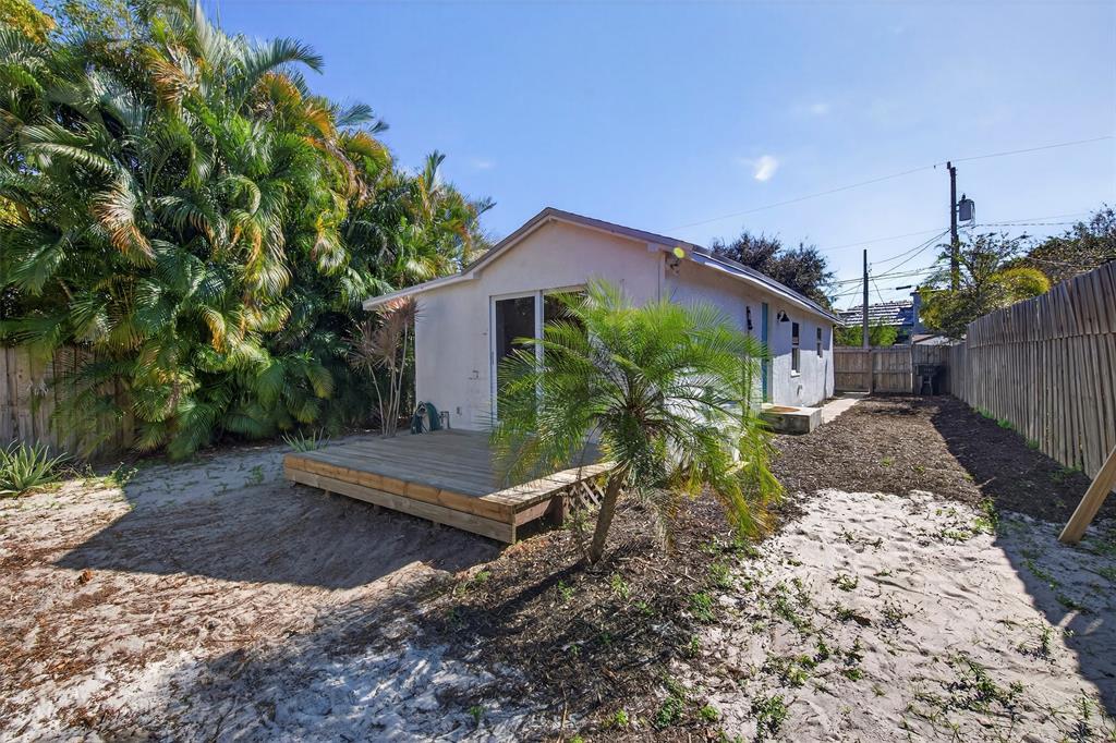 181 Northeast 15th Terrace Boca Raton, FL 33431 - Photo 48 of 51 a view of a house with a yard and a garden