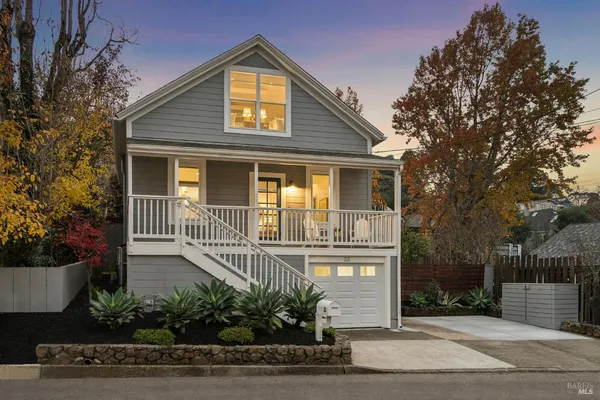 a front view of a house with a garden
