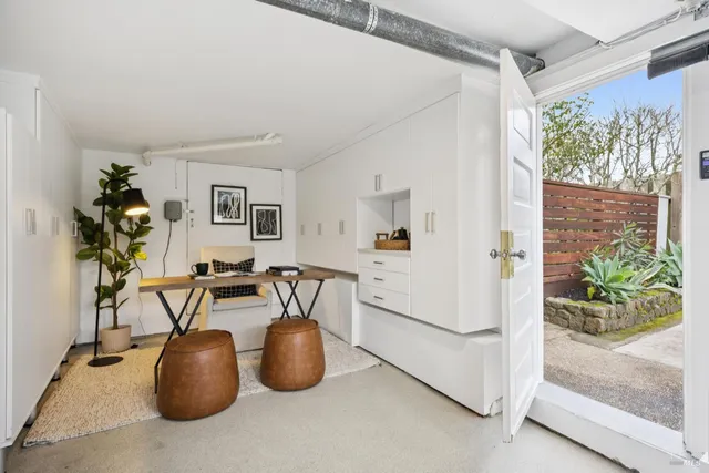 a view of a livingroom with furniture and a potted plant