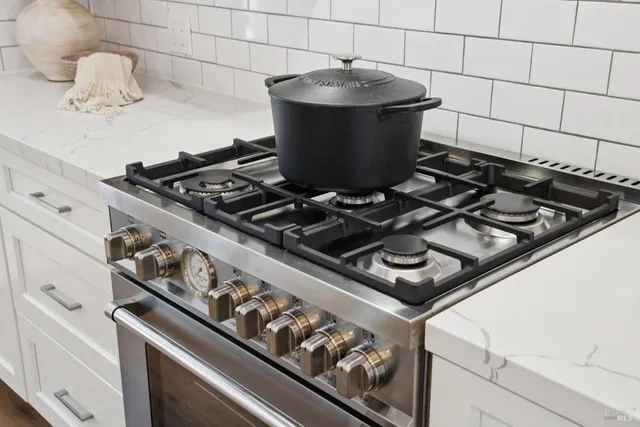 a stove top oven sitting inside of a kitchen