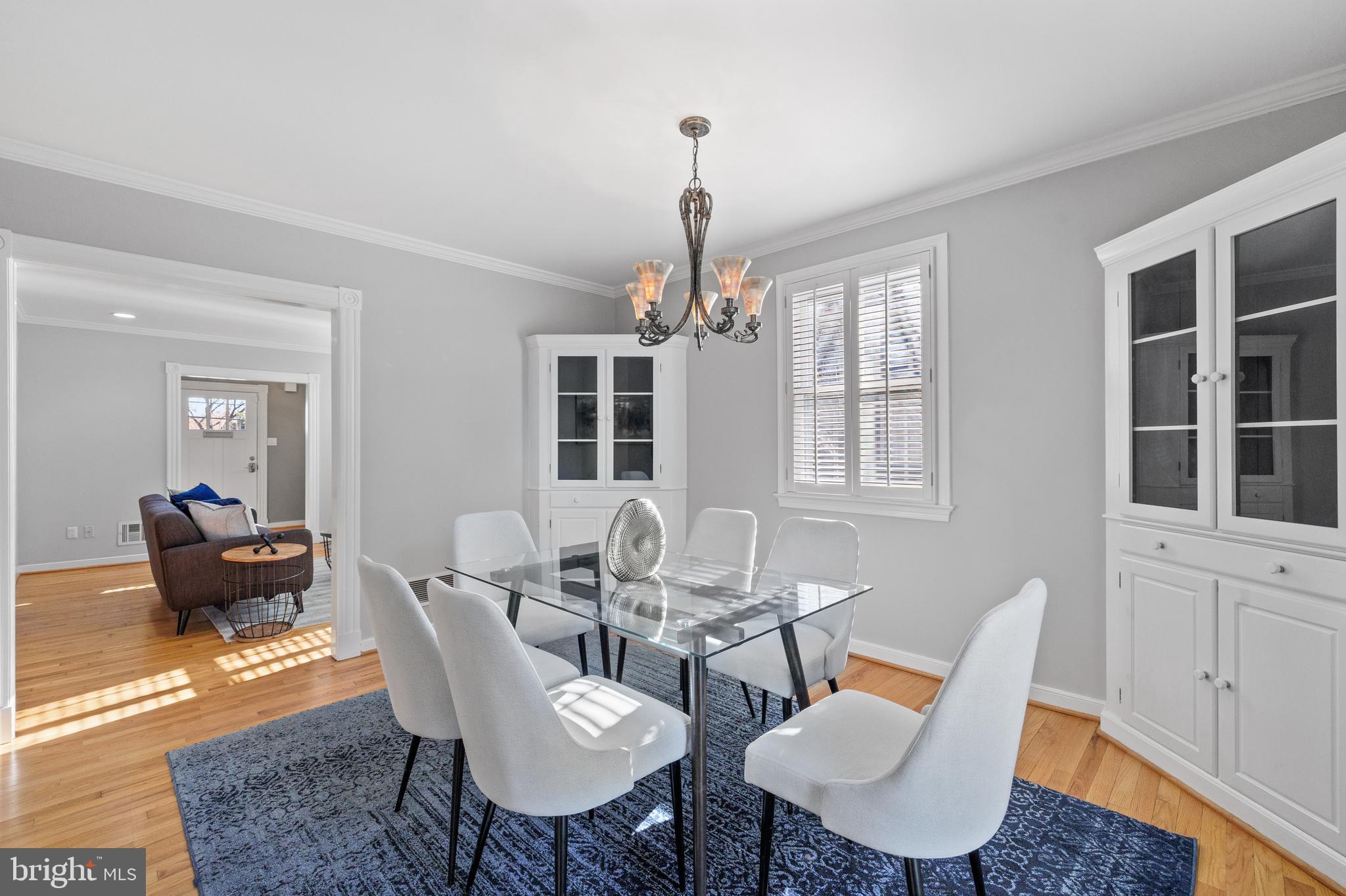202 Russell Road Alexandria, VA 22301 - Photo 23 of 70 a dining room with furniture a chandelier and wooden floor