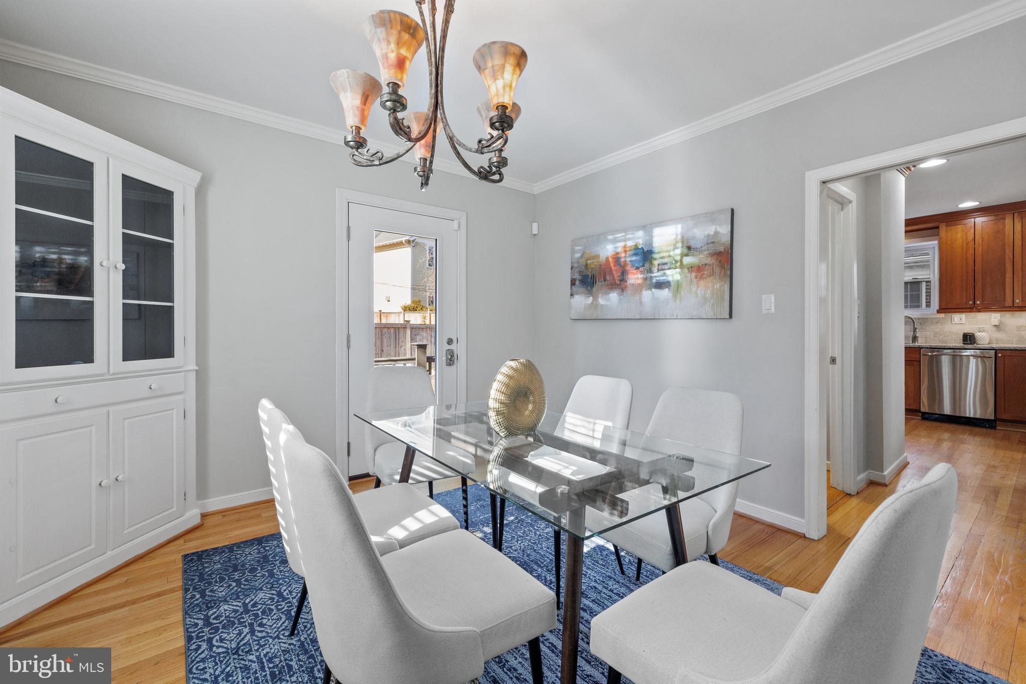 202 Russell Road Alexandria, VA 22301 - Photo 25 of 70 a view of a dining room with furniture wooden floor and a chandelier