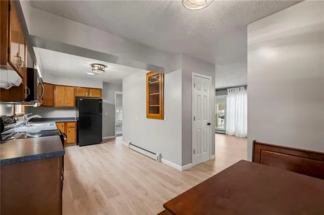 a kitchen with a refrigerator and a sink