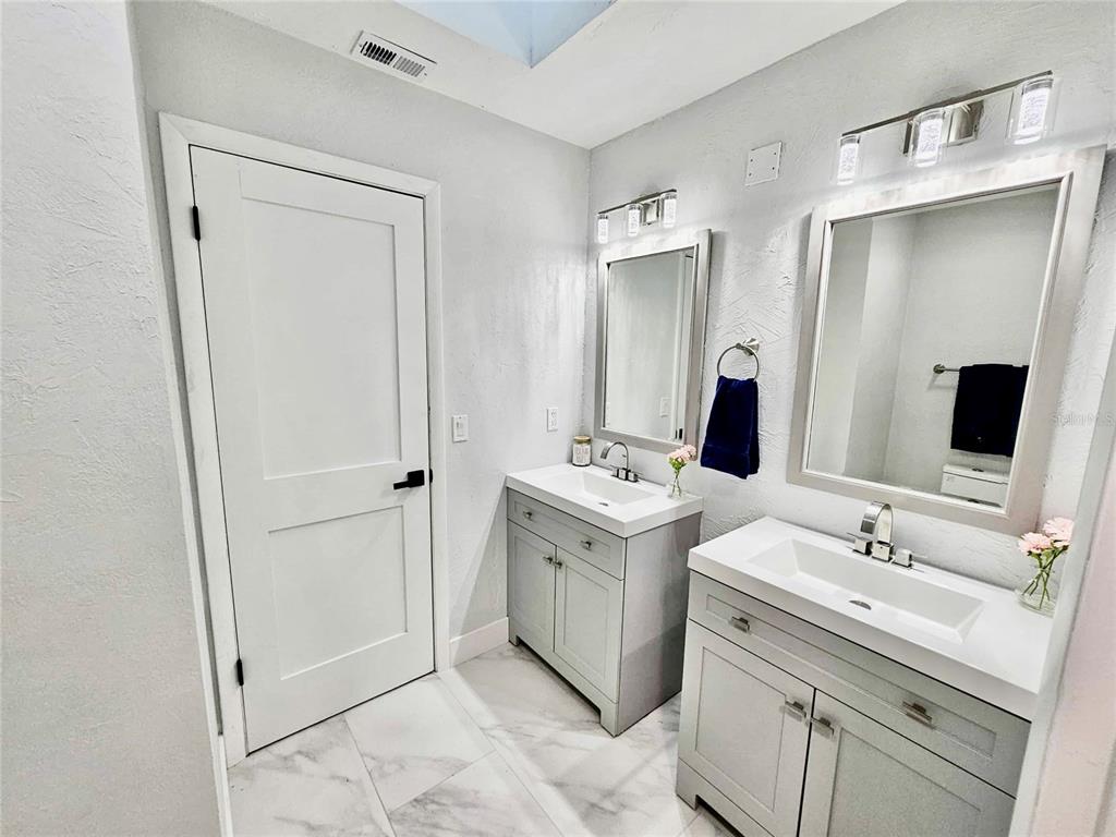 5407 Southwest 82 Terrace Gainesville, FL 32608 - Photo 21 of 31 a spacious bathroom with a double vanity sink and mirror
