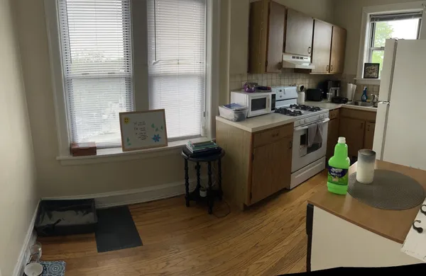 a kitchen with sink cabinets and wooden floor