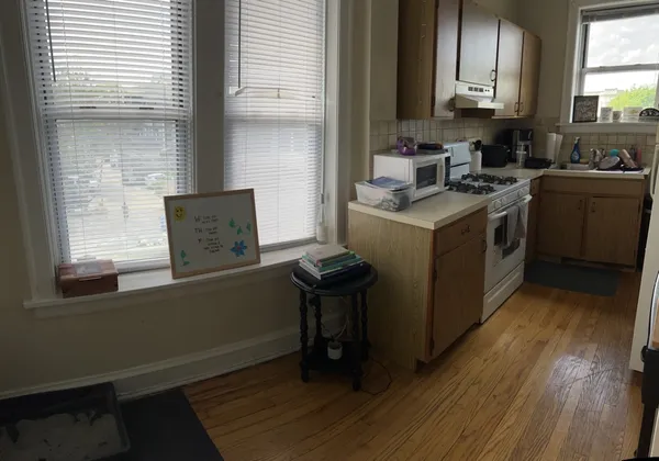 a kitchen with a sink cabinets and wooden floor
