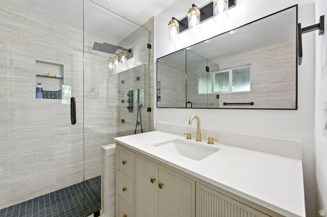 871 Bonita Way Centerville, UT 84014 - Photo 14 of 61 Modern bathroom featuring a single vanity with a white countertop and gold-finish faucet