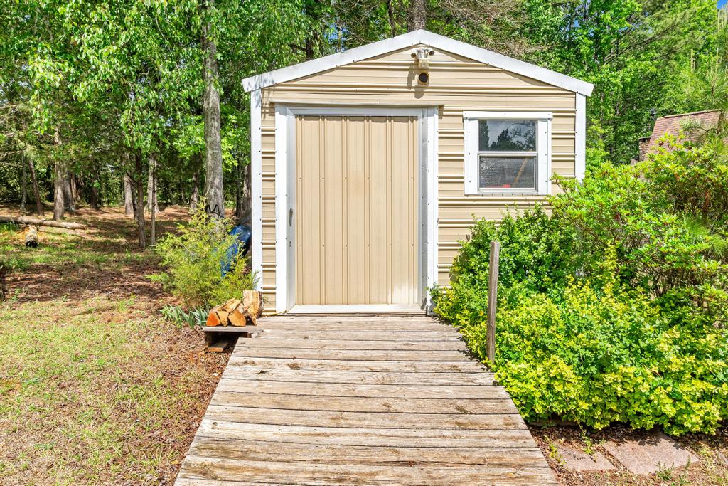 848 Perkins Creek Road Seneca, SC 29678 - Photo 24 of 26 This charming utility shed offers practical storage amidst a serene, natural setting.