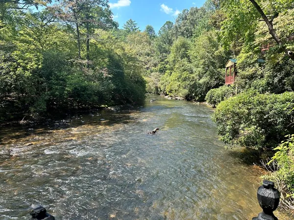 a view of wooden house with a bench