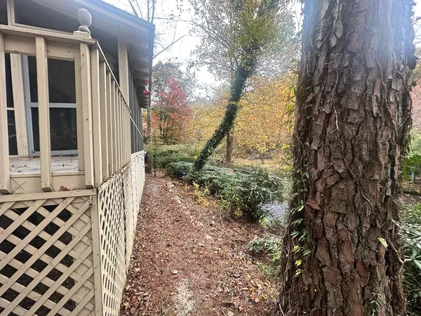 a balcony with wooden fence and trees