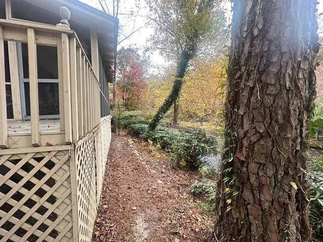a balcony with wooden fence and trees