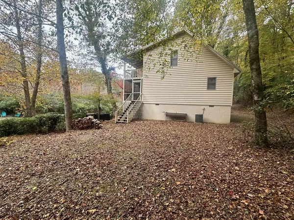 a white house that has a tree in front of it