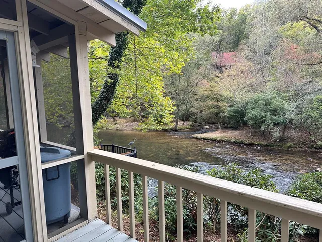 a view of a roof deck with wooden floor and fence