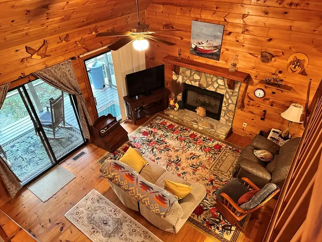 a living room with furniture a flat screen tv and a fireplace