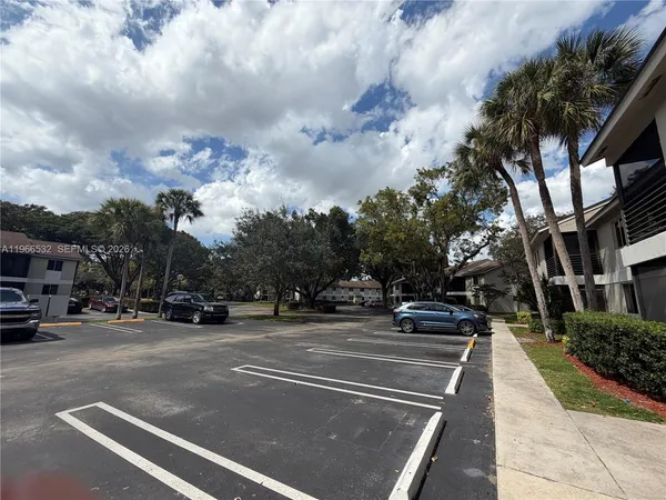 a view of a city street from a cars parked on the roadside