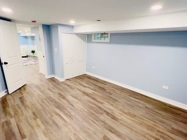 a view of a kitchen with wooden floor and a sink
