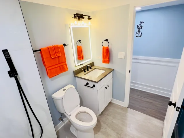 a bathroom with a toilet a sink and a shower