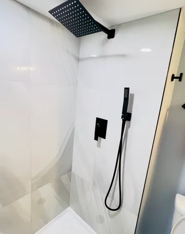 a bathroom with a shower and toilet