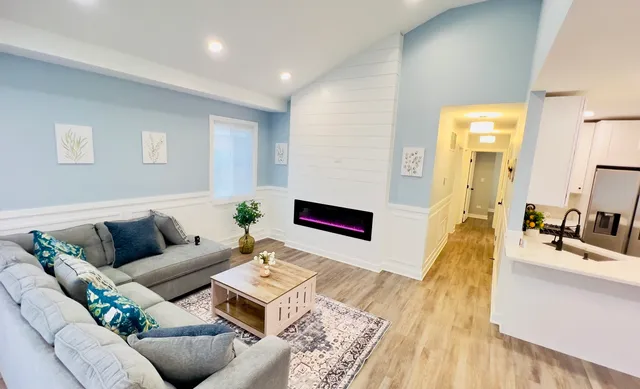 a living room with furniture and a wooden floor