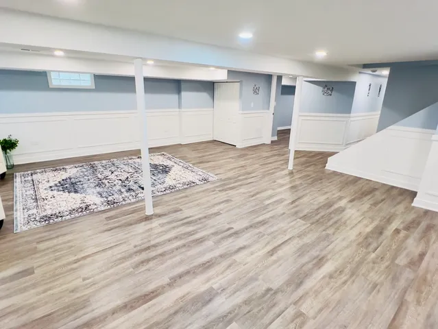 an empty room with wooden floor and cabinet