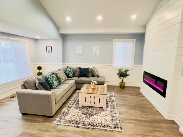 a living room with furniture and wooden floor