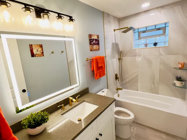 a bathroom with a sink a toilet and a shower curtain