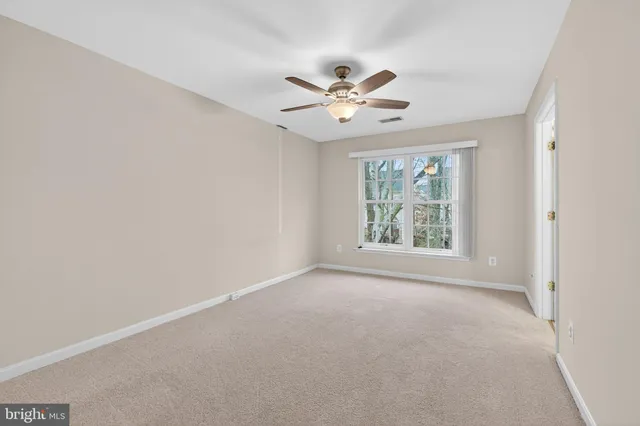 a view of room with window and ceiling fan