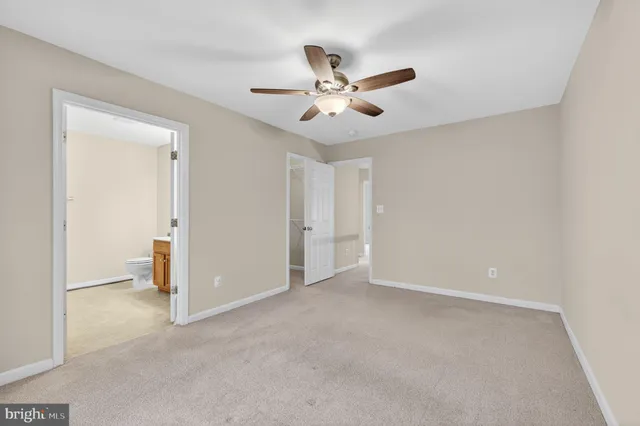 a view of an empty room and closet area