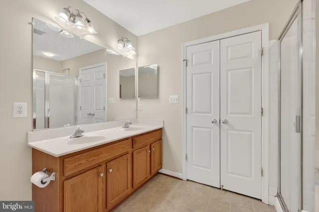 a bathroom with a sink double vanity and a mirror