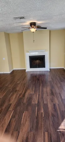 a view of empty room with a fireplace