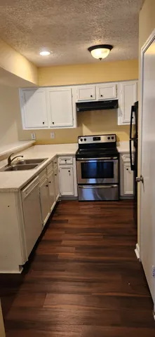 a kitchen with a stove and a microwave