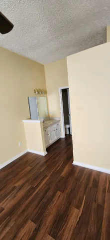 a view of bedroom with wooden floor