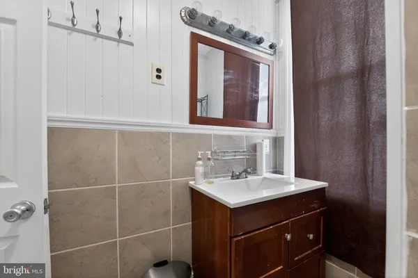 a bathroom with a sink vanity and a mirror
