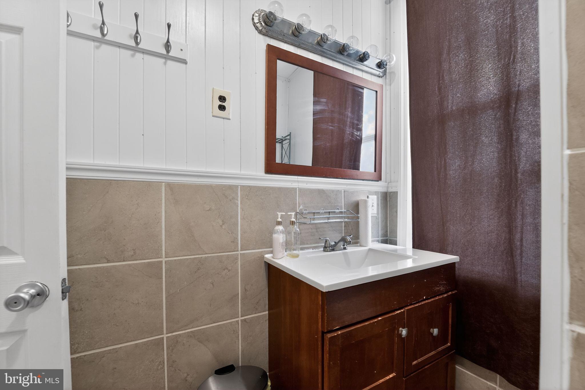 3127 Lawnview Avenue Baltimore, MD 21213 - Photo 14 of 15 a bathroom with a sink vanity and a mirror