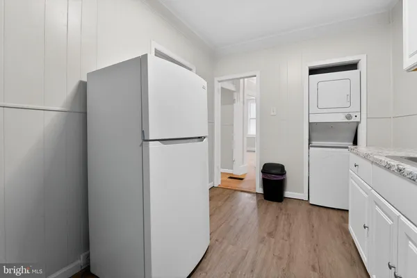 a kitchen with a refrigerator and a stove top oven