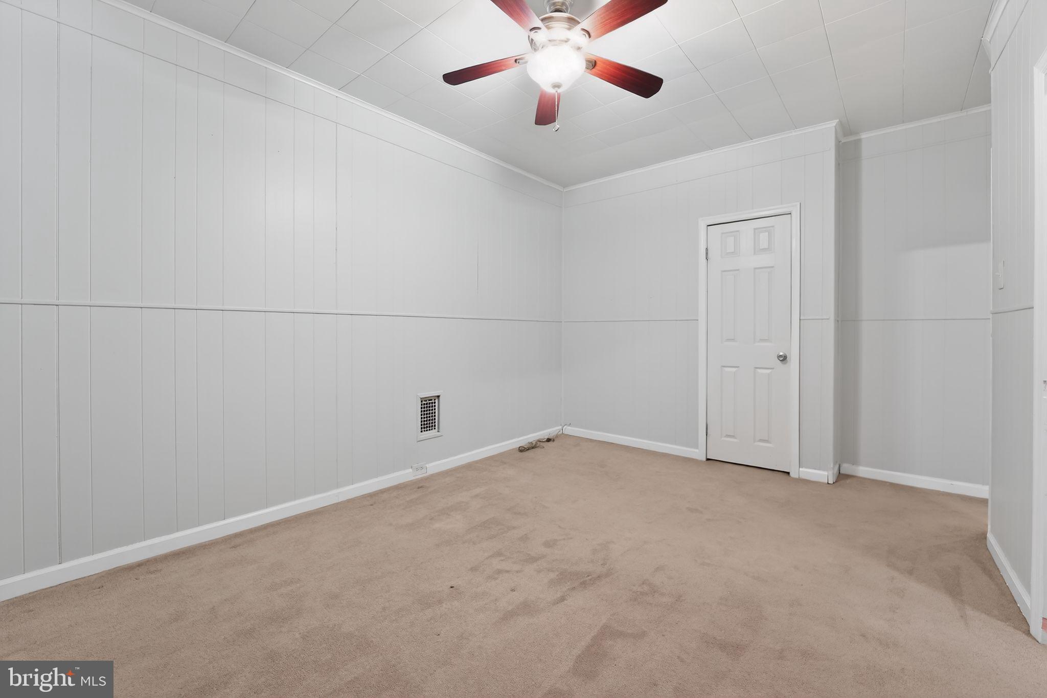 3127 Lawnview Avenue Baltimore, MD 21213 - Photo 8 of 15 an empty room with chandelier fan