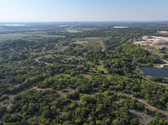 an aerial view of residential house with green space