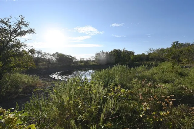 a view of water covered with snow in the background