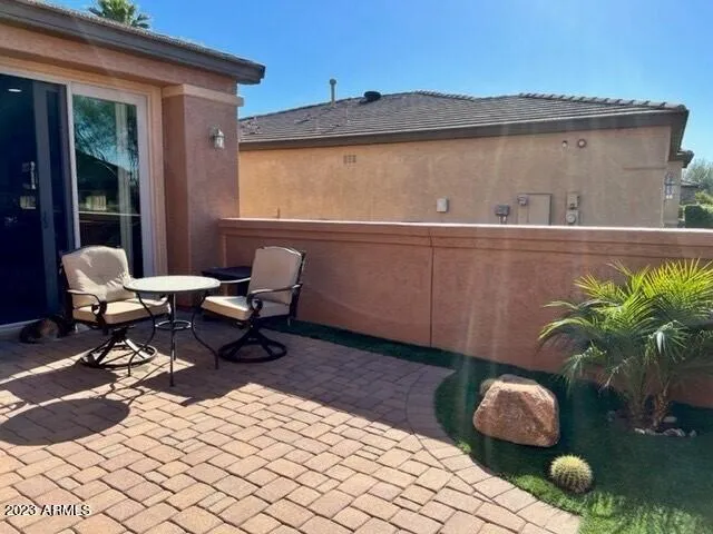 a building outdoor space with patio furniture and potted plants