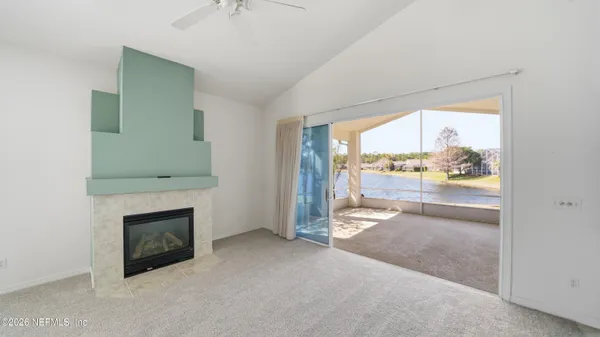a bedroom with a large bed and a potted plant