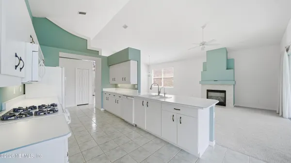 a bathroom with a double vanity sink and mirror with bathtub