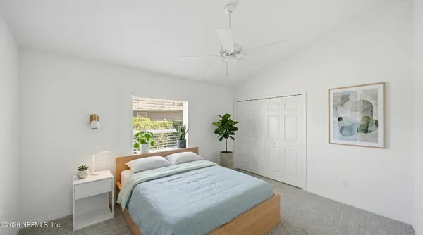 an aerial view of a house with swimming pool and large trees