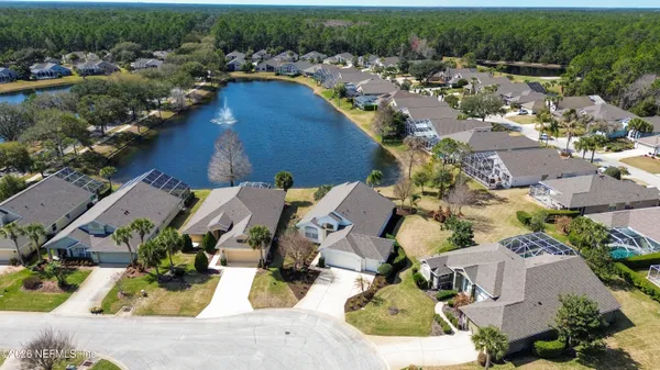 a view of swimming pool with outdoor seating and house in the background