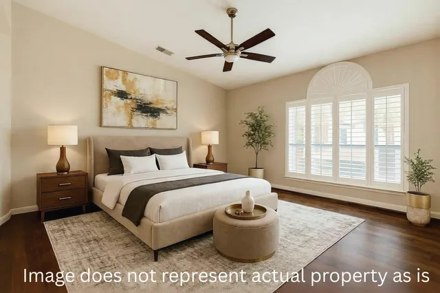 a living room with a bed and a large window