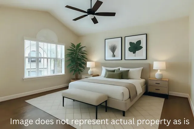 a bedroom with a bed and a painting on the wall