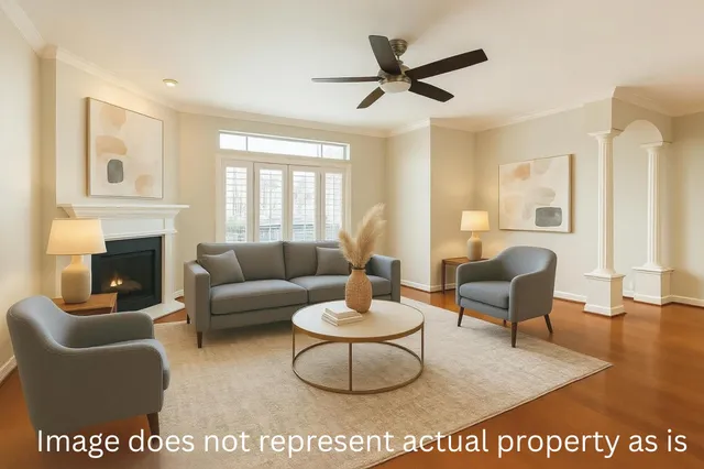 a living room with furniture a fireplace and a large window