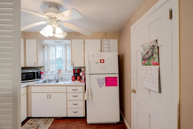 a bed room with a bed mirror and a chandelier