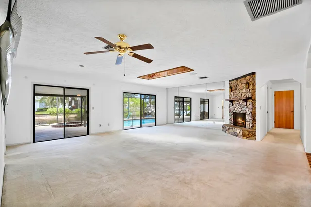 a view of a livingroom with a ceiling fan and window