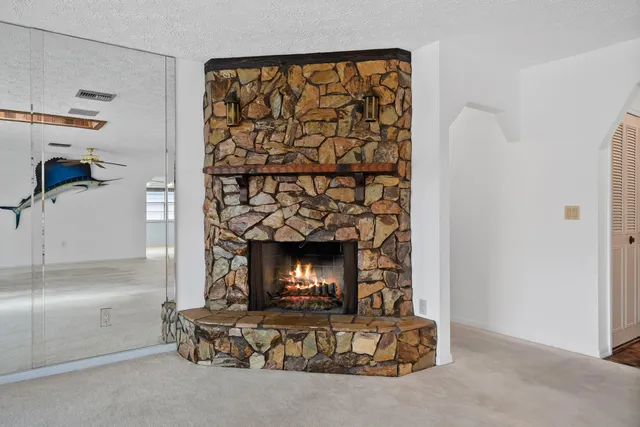 an empty room with sliding glass door and mountain view